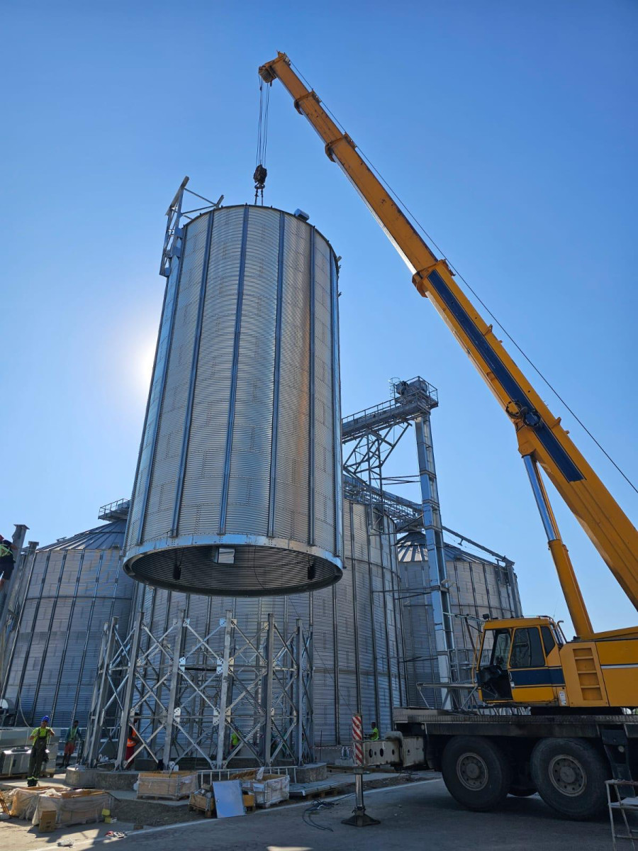 crane lifting hopper silos